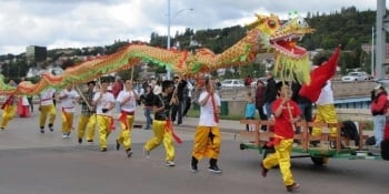 Students carrying a dragon in the parade.